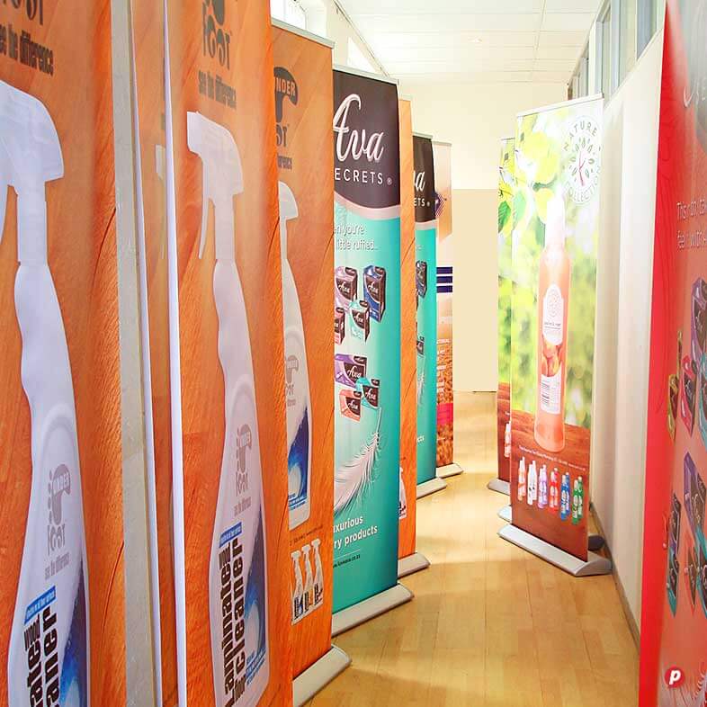 Promotional banners for Hot Ink products displayed in a retail store aisle.